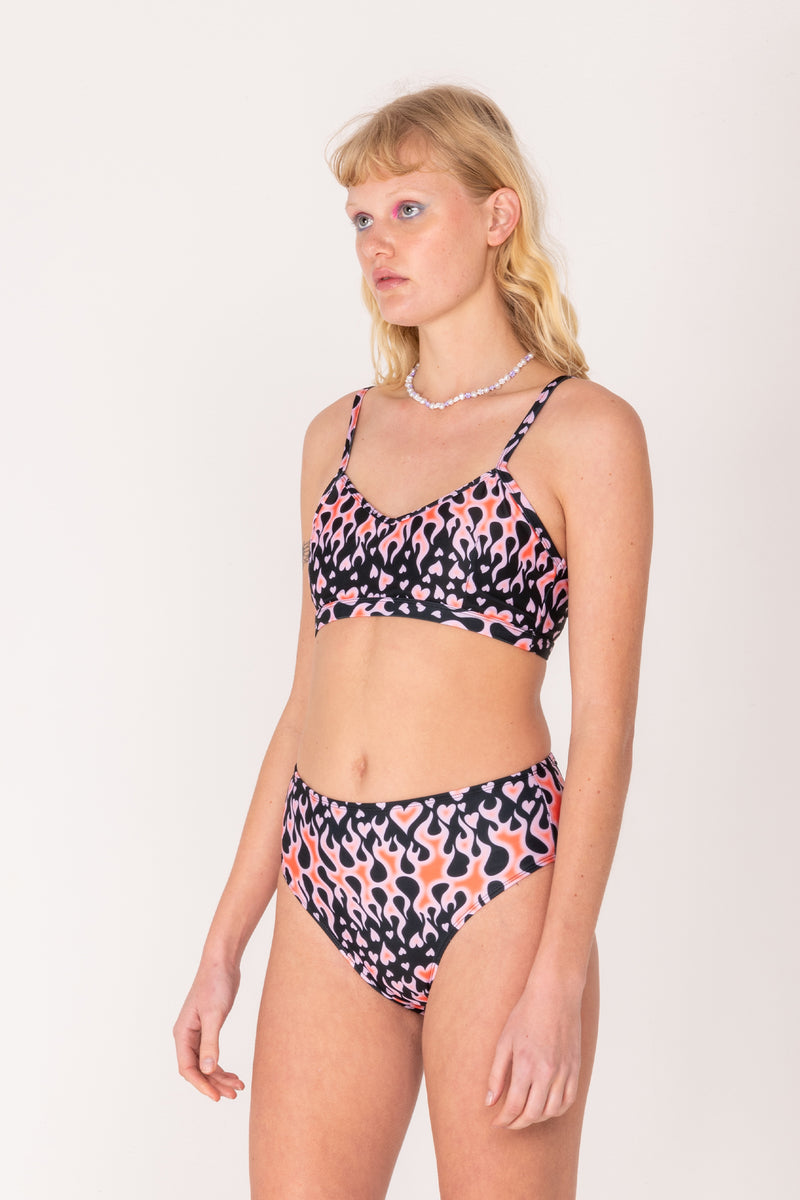 Woman wearing a colorful bikini set on a white background