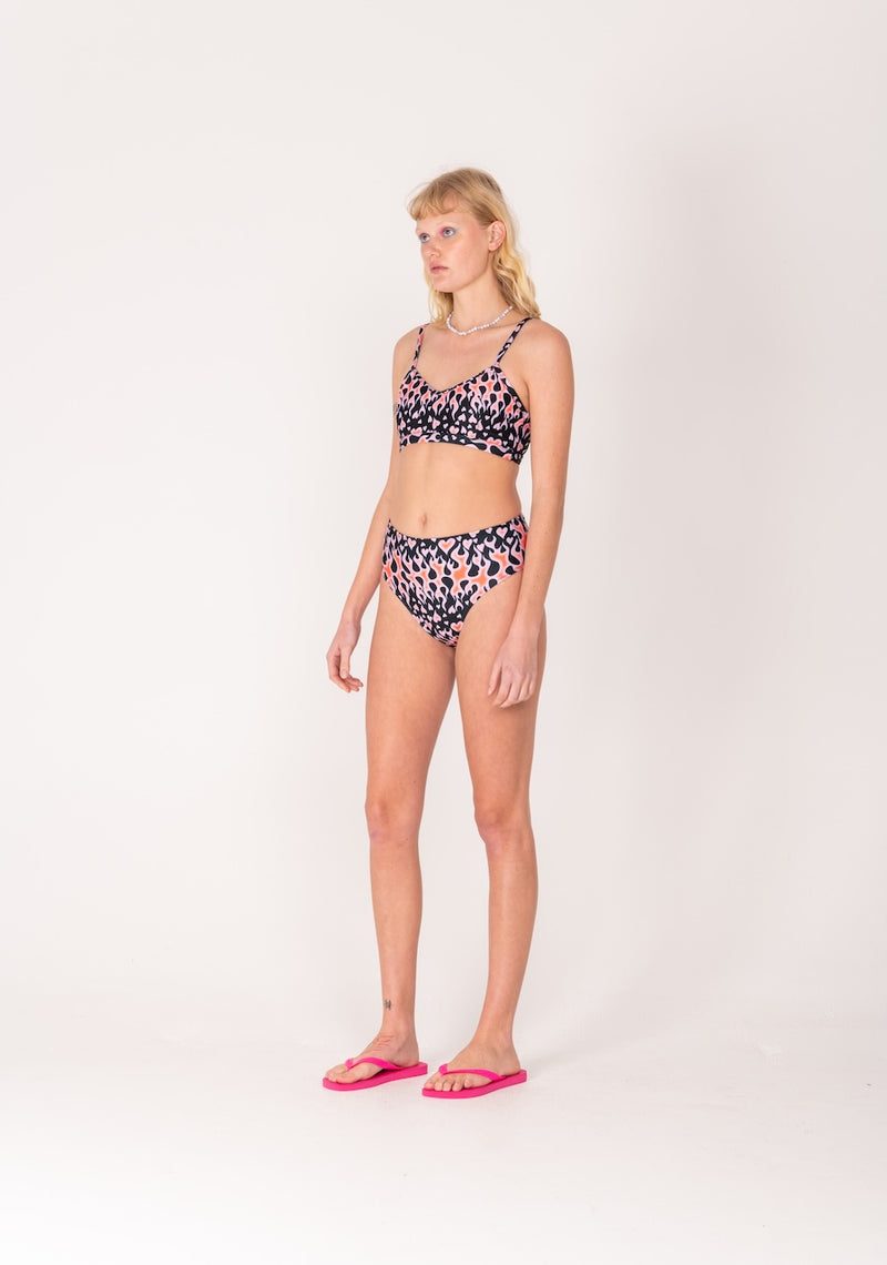 Woman wearing a floral bikini set on a white background