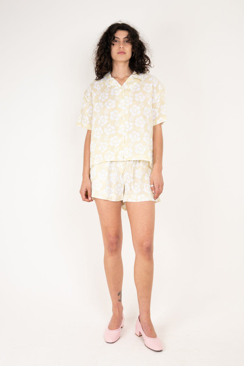 Woman wearing a light-colored outfit with a white background