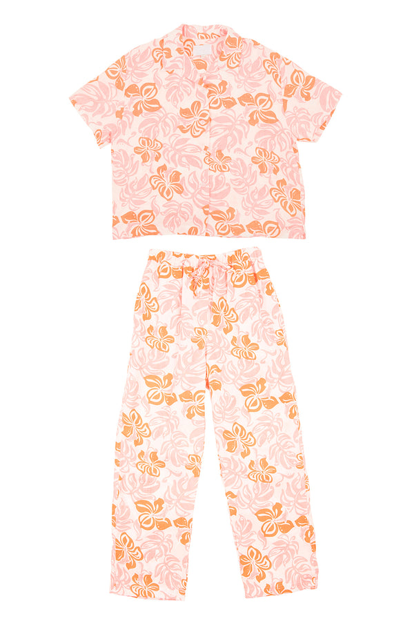 Pink pajama set with orange floral pattern on a white background