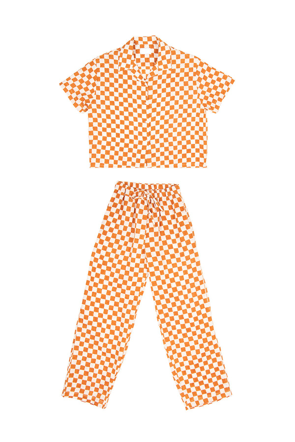 Orange and white checkered outfit with top and pants on a white background