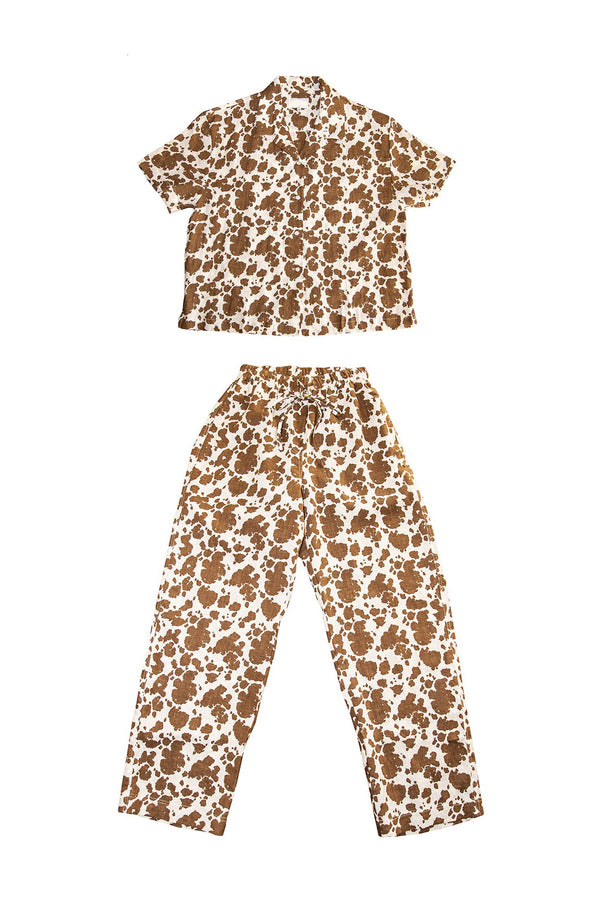 Two-piece outfit with a patterned shirt and pants on a white background