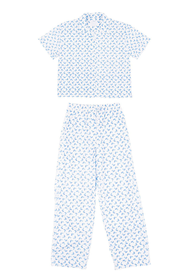 Two-piece outfit with a top and pants featuring a small pattern on a white background