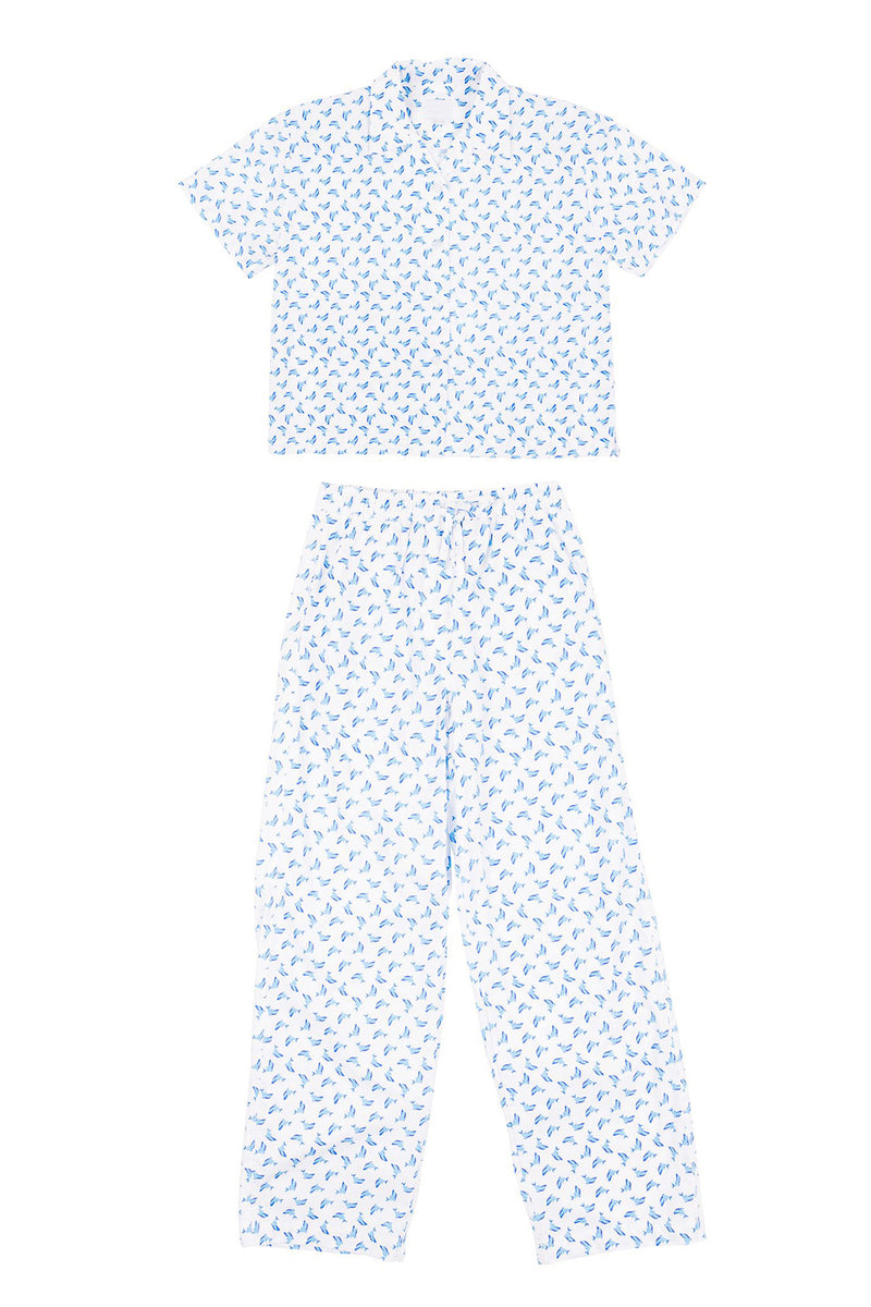 Two-piece outfit with a top and pants featuring a small pattern on a white background