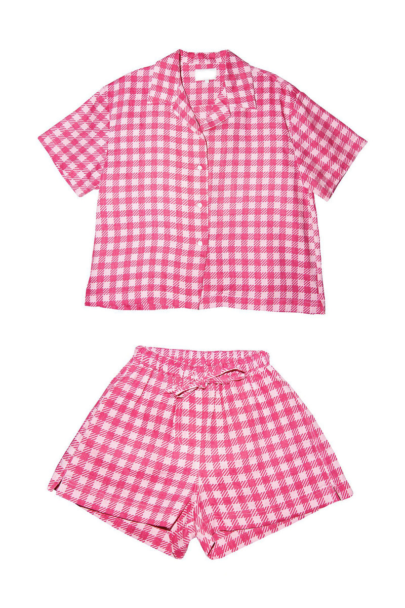Pink and white checkered pajama set on a white background