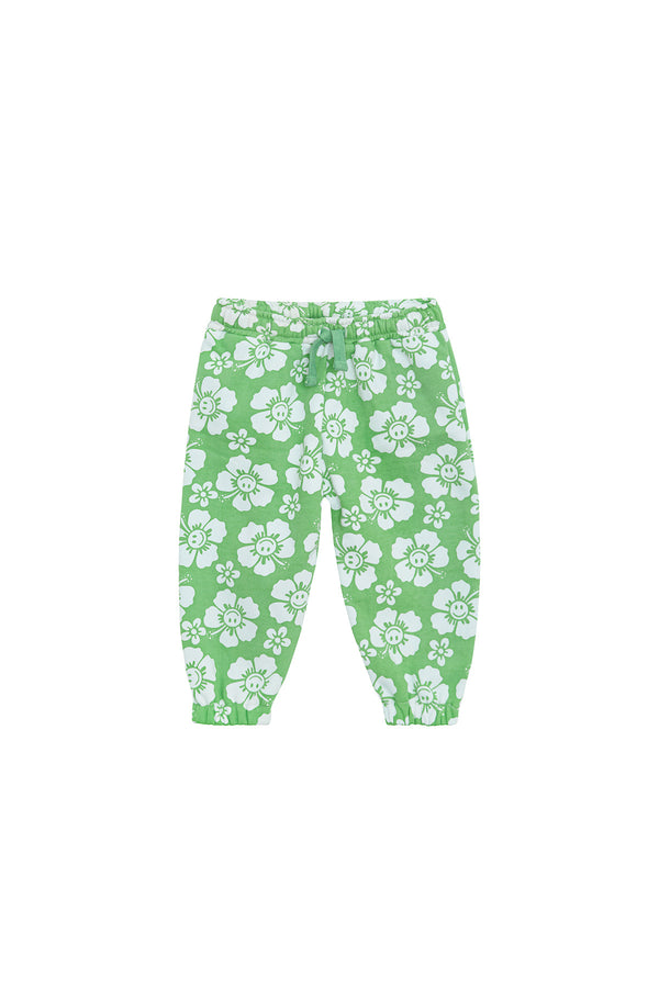 Green pants with white happy hibiscus pattern on a white background