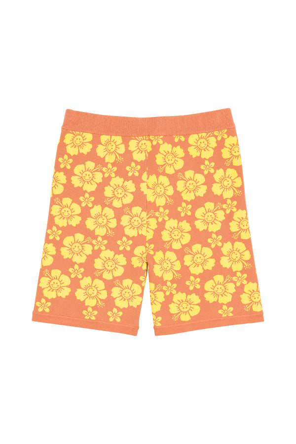 Orange shorts with yellow floral pattern on a white background
