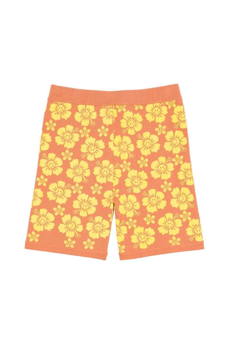 Orange shorts with yellow floral pattern on a white background