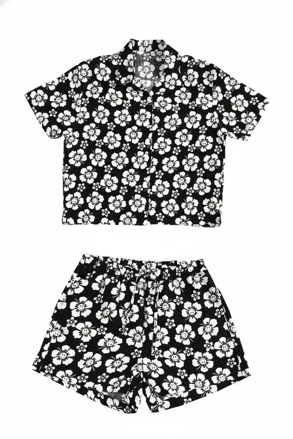 Black and white floral shirt and shorts set on a white background