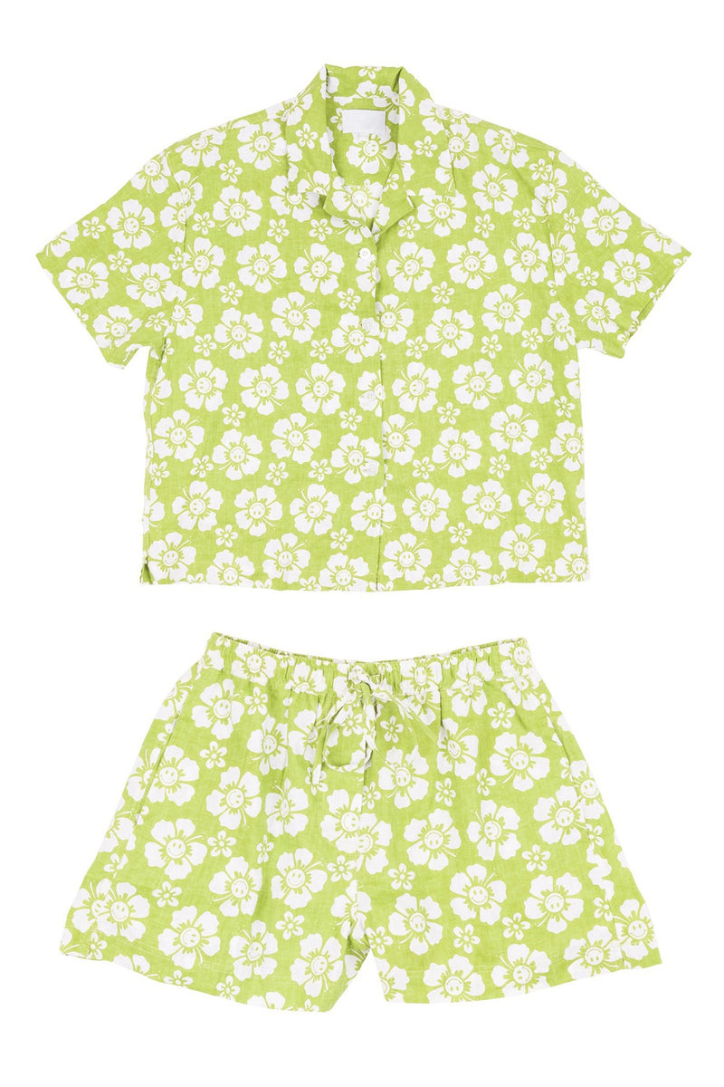 Green and white floral shirt and shorts set on a white background
