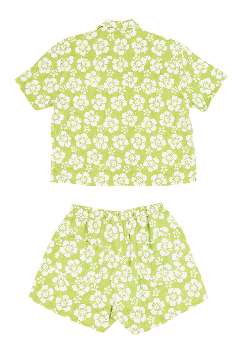 Green and white floral shirt and shorts set on a white background