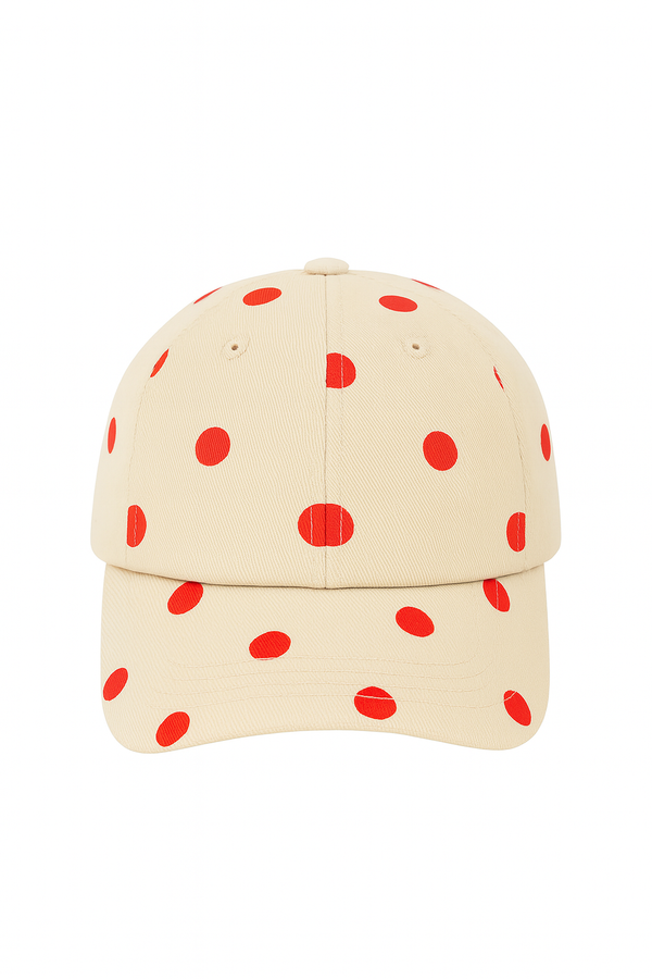 Cream cap with red polka dots on a white background