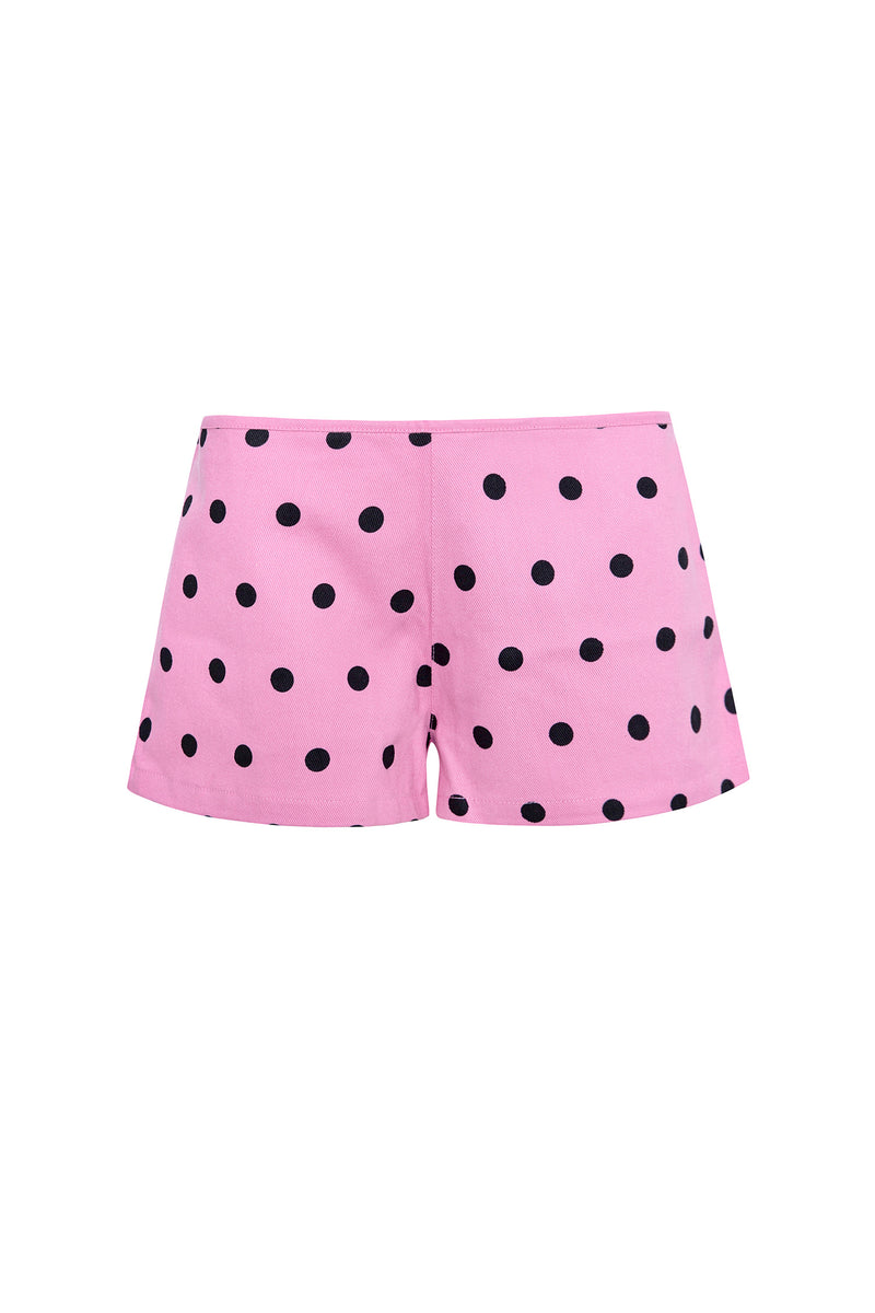 Pink shorts with black polka dots on a white background