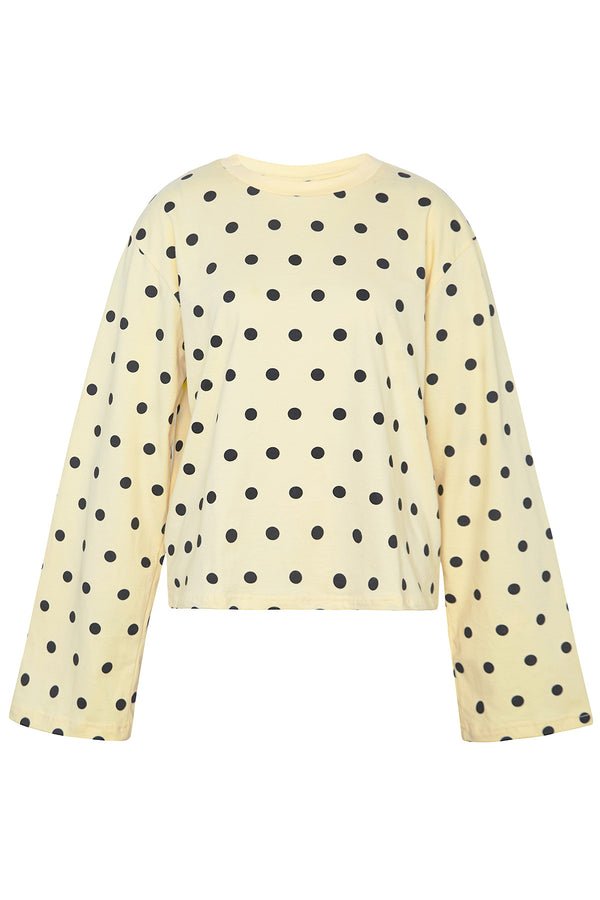 Yellow sweater with black polka dots on a white background