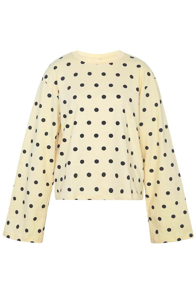 Yellow sweater with black polka dots on a white background