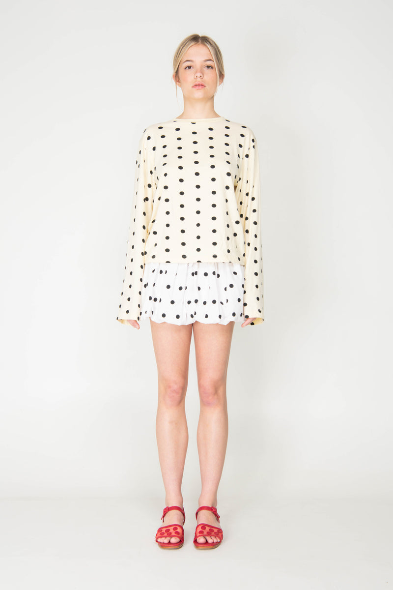 Woman wearing a polka dot dress on a white background