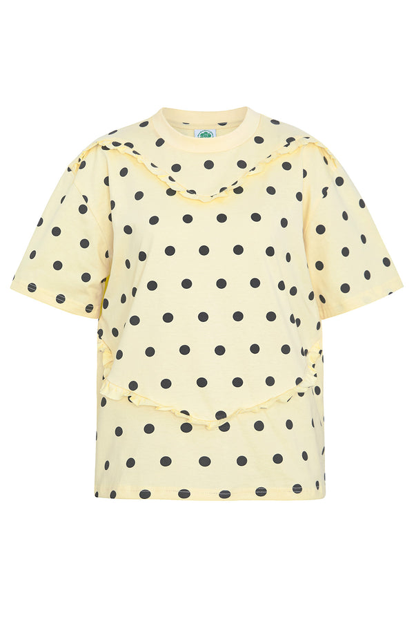Yellow top with black polka dots on a white background