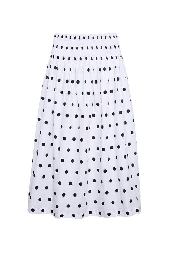 White skirt with black polka dot pattern on a white background