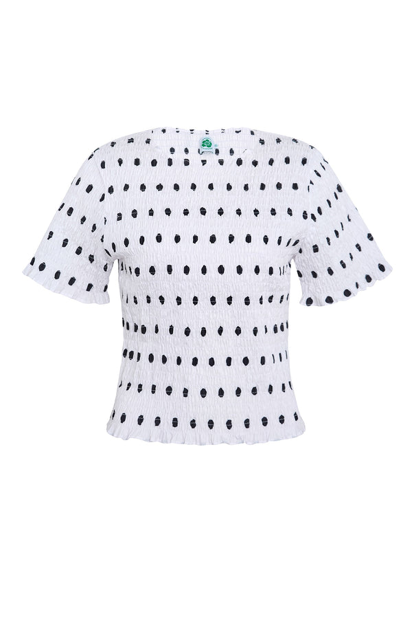 White blouse with black polka dots on a white background