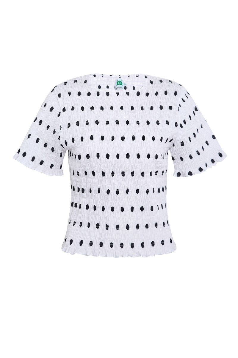 White blouse with black polka dots on a white background