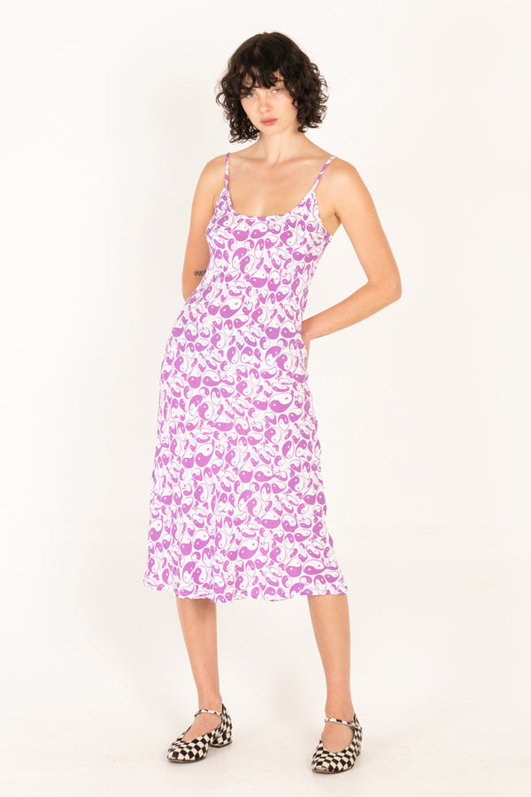 Woman wearing a purple floral dress on a white background