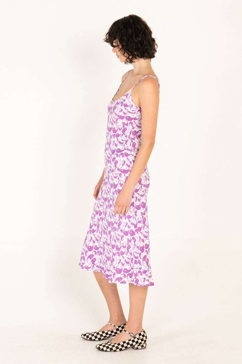 Woman wearing a purple floral dress on a white background
