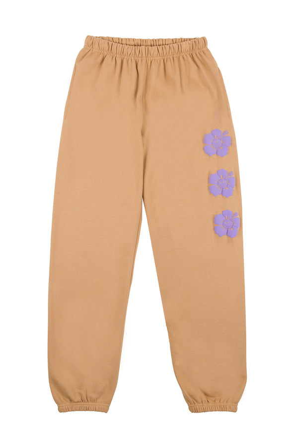 Beige sweatpants with purple floral patterns on a white background