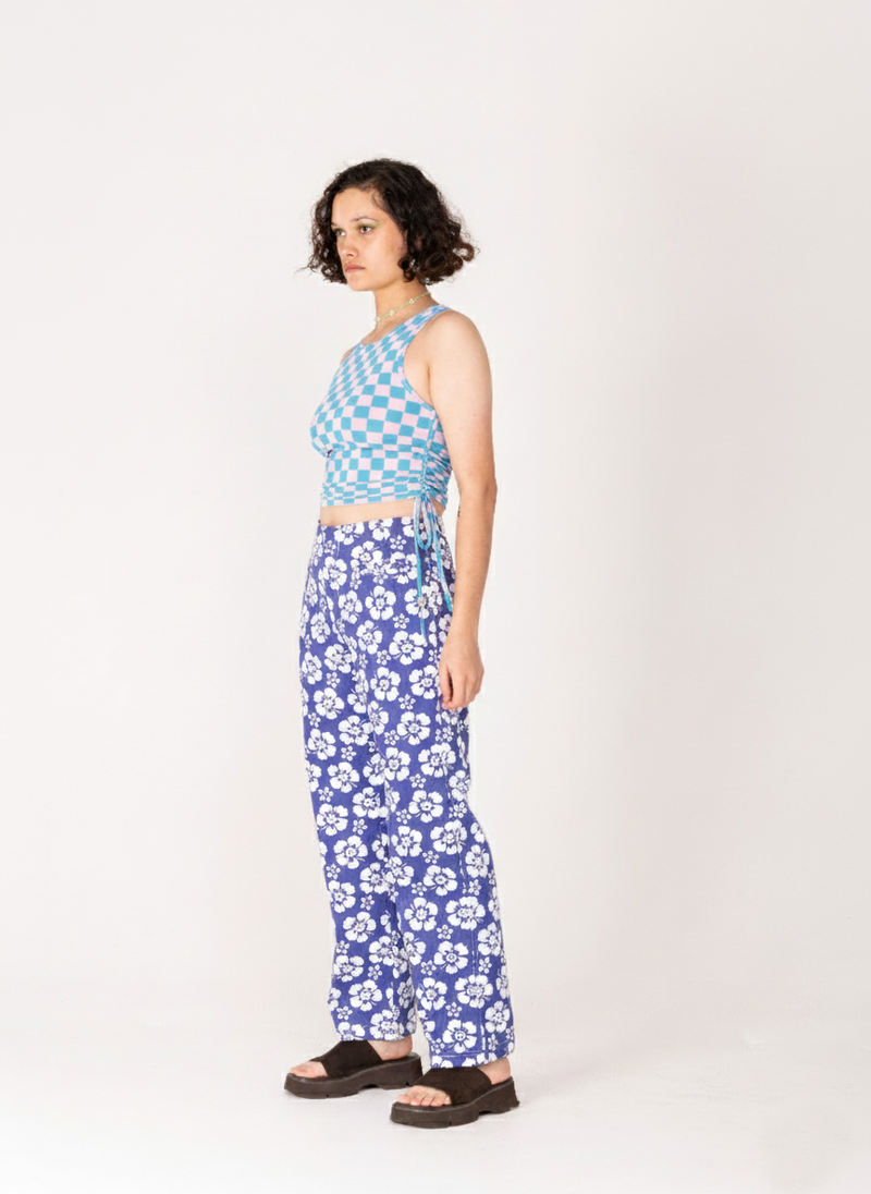 Woman wearing a blue and white patterned outfit on a white background